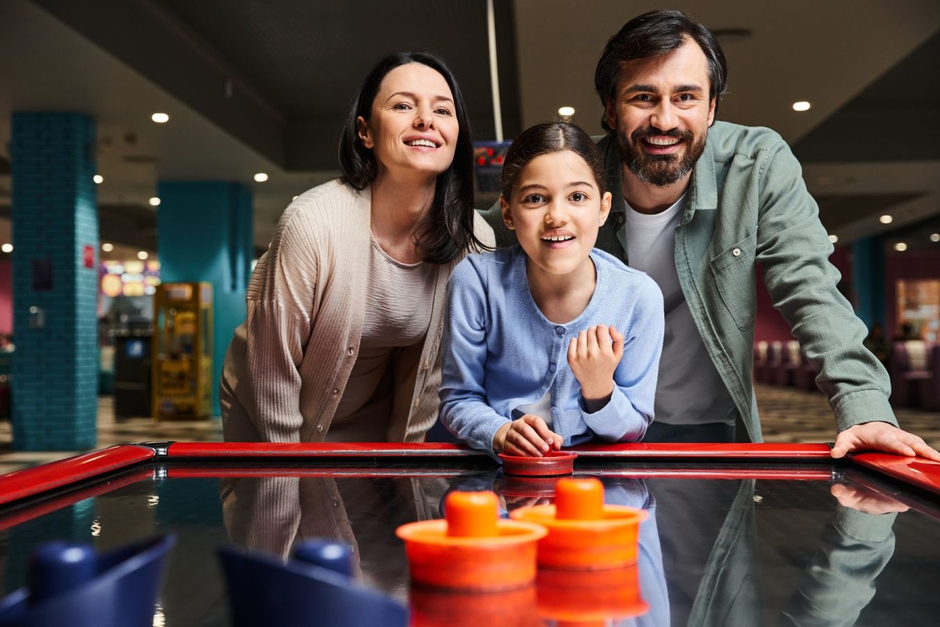 Family playing air hockey