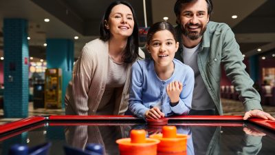 Family playing air hockey